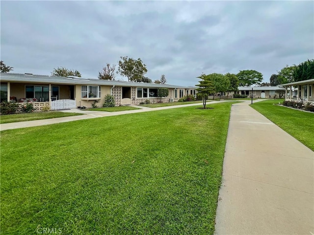 13580 Medinac Ln Unit M5-E, Seal Beach, CA 90740 - view of front facade featuring a front yard and stucco siding