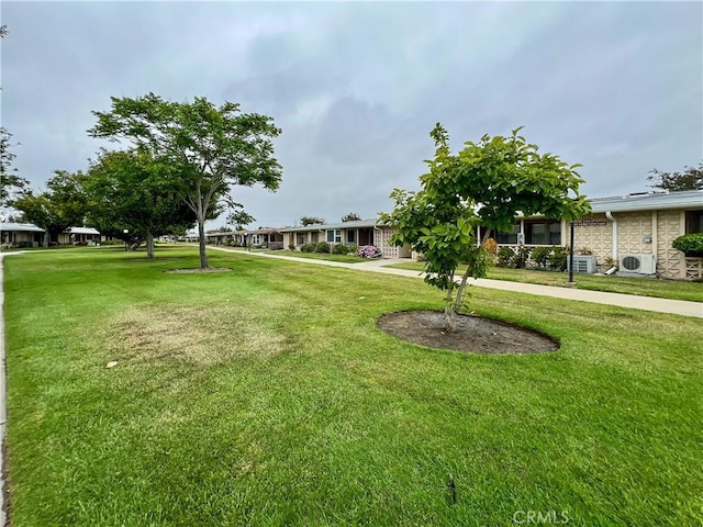 13580 Medinac Ln Unit M5-E, Seal Beach, CA 90740 - view of grassy yard with ac unit and cooling unit