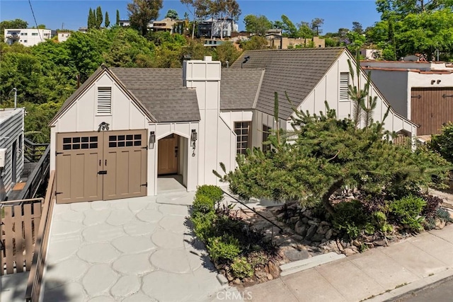 2376 Lake View Ave, Los Angeles, CA 90039 - tudor home with board and batten siding, a shingled roof, and a chimney