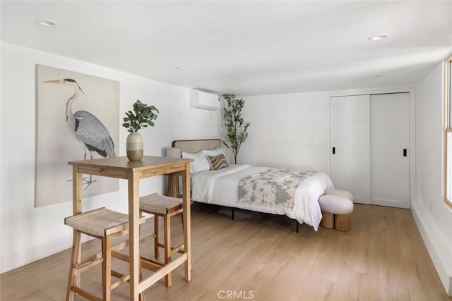 2376 Lake View Ave, Los Angeles, CA 90039 - bedroom with an AC wall unit, light wood-style flooring, and a closet