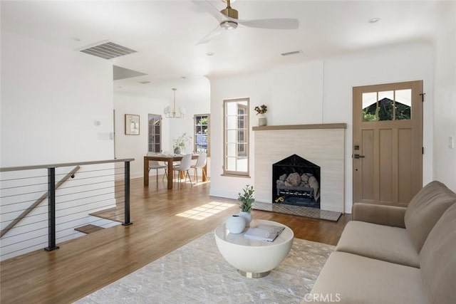 2376 Lake View Ave, Los Angeles, CA 90039 - living room featuring wood finished floors, a ceiling fan, a chandelier, and a fireplace