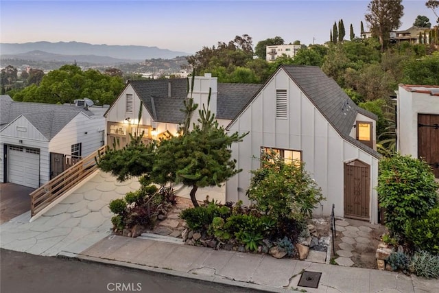 2376 Lake View Ave, Los Angeles, CA 90039 - view of front of home featuring board and batten siding, roof with shingles, a mountain view, and asphalt driveway