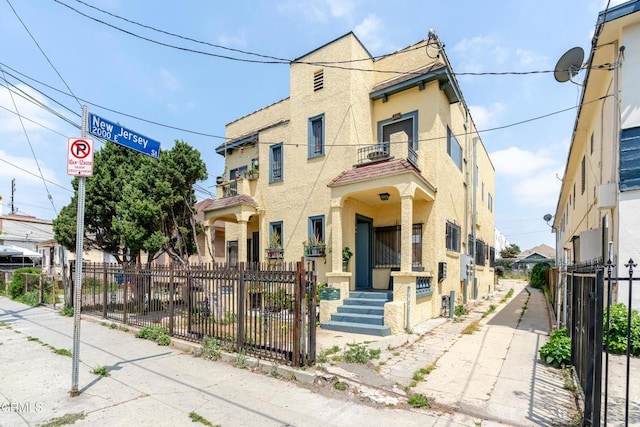 332 N St Louis St, Los Angeles, CA 90033 - view of front of home featuring stucco siding and a balcony
