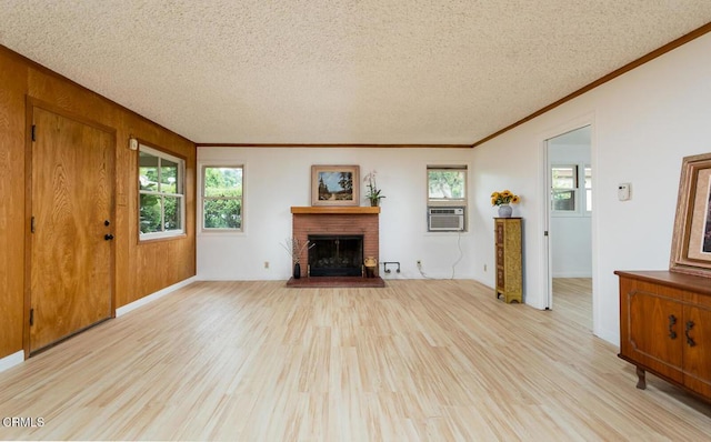 2238 Garfias Dr, Pasadena, CA 91104 - unfurnished living room featuring light wood-style flooring, a textured ceiling, ornamental molding, cooling unit, and a fireplace