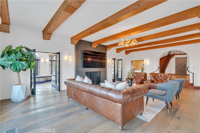 1812 Linda Vista Ave, Pasadena, CA 91103 - living area featuring beamed ceiling, wood finished floors, a large fireplace, stairs, and arched walkways