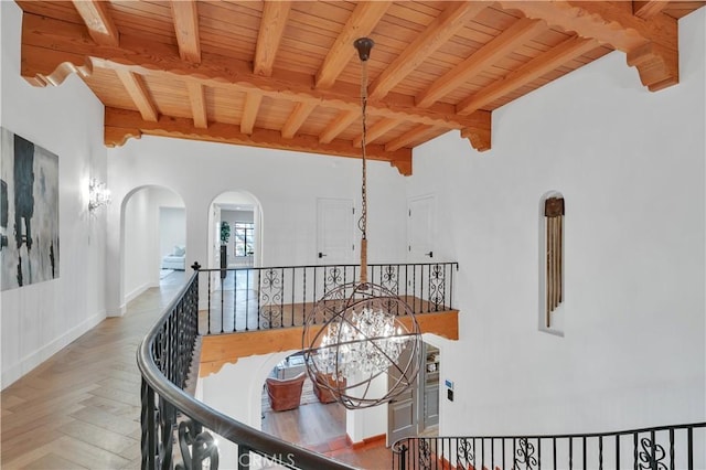 1812 Linda Vista Ave, Pasadena, CA 91103 - hall with an upstairs landing, wooden ceiling with exposed beams, arched walkways, wood finished floors, and a chandelier