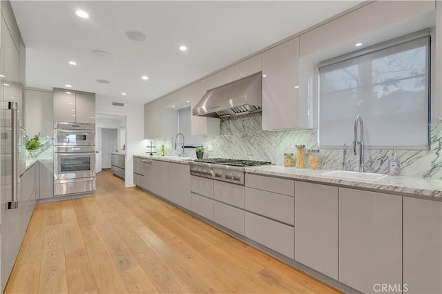 1812 Linda Vista Ave, Pasadena, CA 91103 - kitchen with modern cabinets, exhaust hood, a sink, light wood-style floors, and recessed lighting