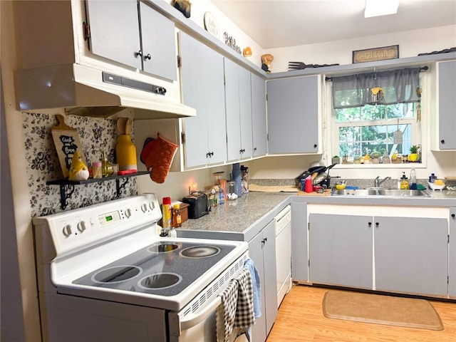 216 College Ave, Weed, CA 96094 - kitchen featuring white appliances, a sink, under cabinet range hood, light wood-style flooring, and light countertops