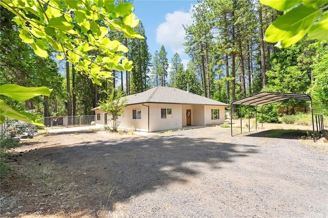 4930 Contentment Ln, Forest Ranch, CA 95942 - view of property exterior with gravel driveway, stucco siding, and a detached carport