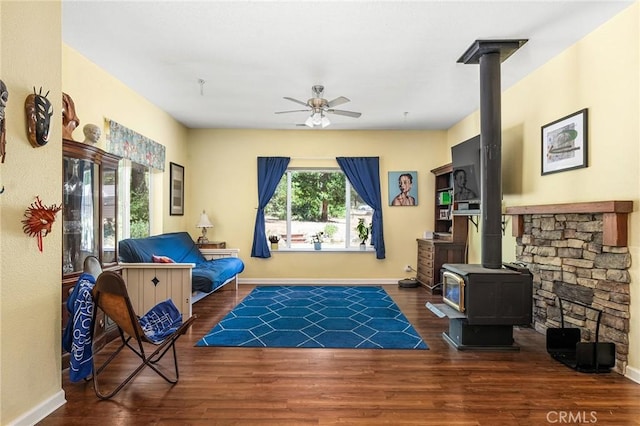 4930 Contentment Ln, Forest Ranch, CA 95942 - living area featuring a wood stove, ceiling fan, wood finished floors, and baseboards