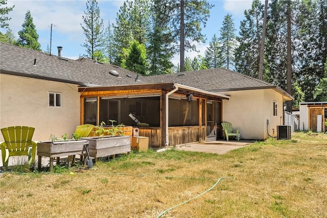 4930 Contentment Ln, Forest Ranch, CA 95942 - back of house with a sunroom, stucco siding, roof with shingles, a lawn, and a patio area