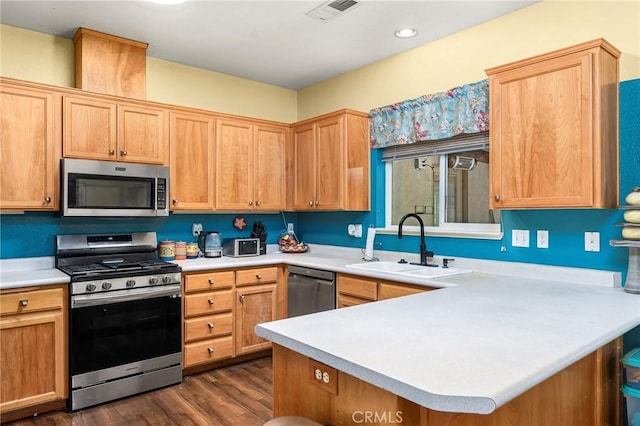 4930 Contentment Ln, Forest Ranch, CA 95942 - kitchen featuring appliances with stainless steel finishes, a sink, a peninsula, light countertops, and dark wood finished floors