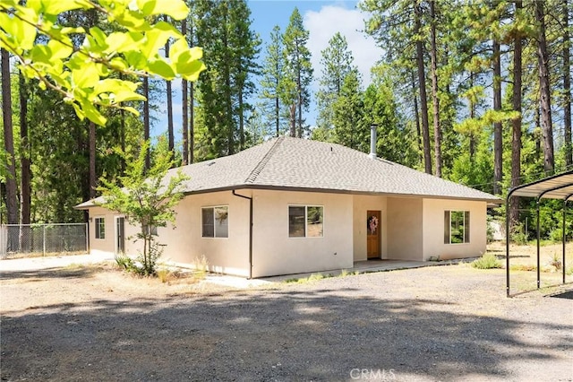 4930 Contentment Ln, Forest Ranch, CA 95942 - view of front facade with stucco siding, gravel driveway, and a shingled roof