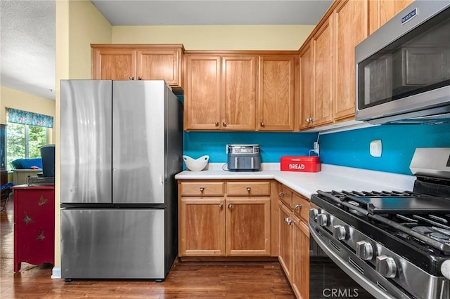 4930 Contentment Ln, Forest Ranch, CA 95942 - kitchen featuring stainless steel appliances, dark wood-style floors, and light countertops