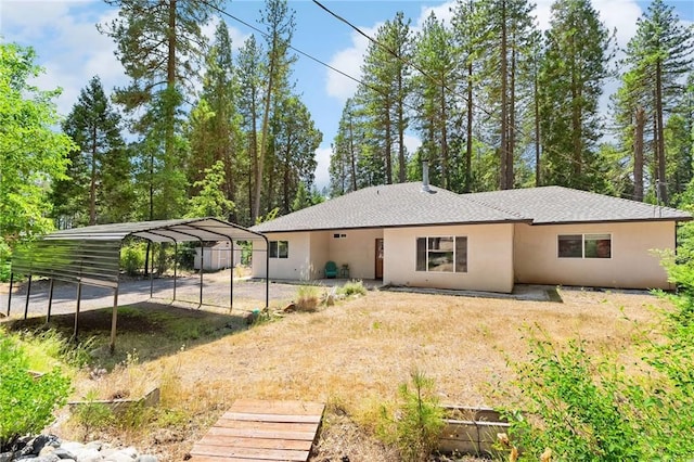 4930 Contentment Ln, Forest Ranch, CA 95942 - back of property with a detached carport, stucco siding, and dirt driveway
