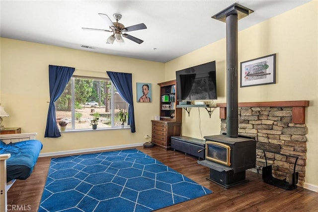 4930 Contentment Ln, Forest Ranch, CA 95942 - living area featuring a wood stove, ceiling fan, wood finished floors, and baseboards