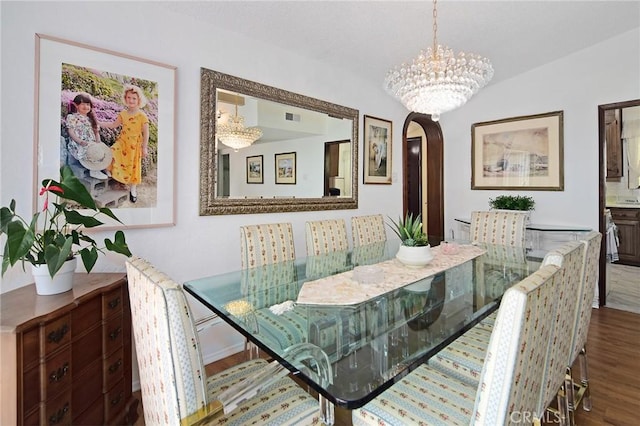 3935 Oakfield Dr, Sherman Oaks, CA 91423 - dining space with arched walkways, wood finished floors, and a chandelier