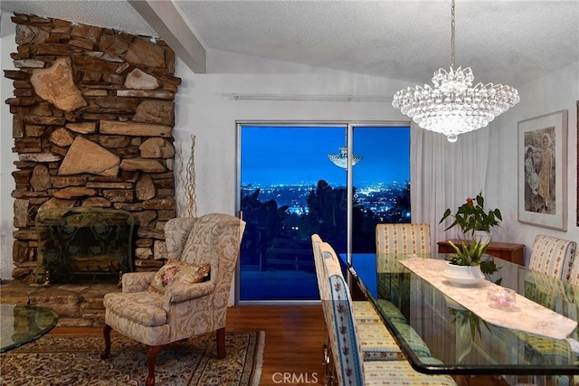 3935 Oakfield Dr, Sherman Oaks, CA 91423 - dining area featuring a chandelier, wood finished floors, a textured ceiling, vaulted ceiling, and a stone fireplace