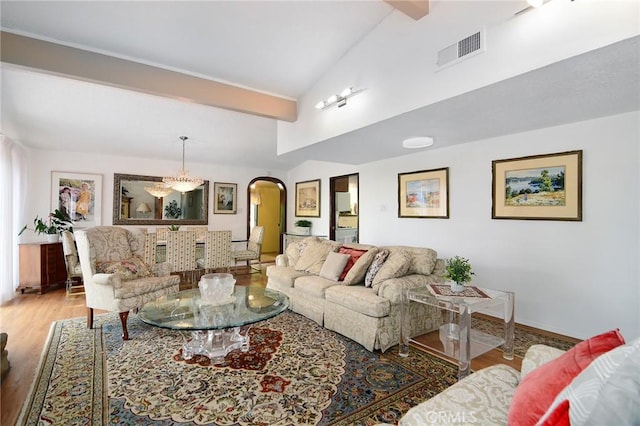 3935 Oakfield Dr, Sherman Oaks, CA 91423 - living room featuring arched walkways, wood finished floors, and baseboards