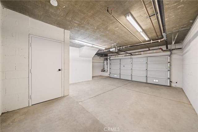 879 Michigan Blvd Unit B, Pasadena, CA 91107 - garage featuring a garage door opener and concrete block wall