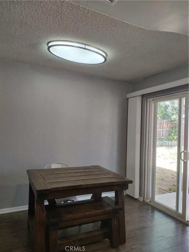 7870 Hopi Trl, Yucca Valley, CA 92284 - dining area featuring dark wood finished floors and a textured ceiling