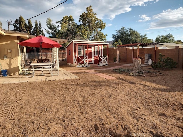 7870 Hopi Trl, Yucca Valley, CA 92284 - fenced backyard featuring a patio area and a storage unit