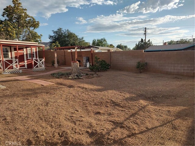 7870 Hopi Trl, Yucca Valley, CA 92284 - fenced backyard featuring a patio area