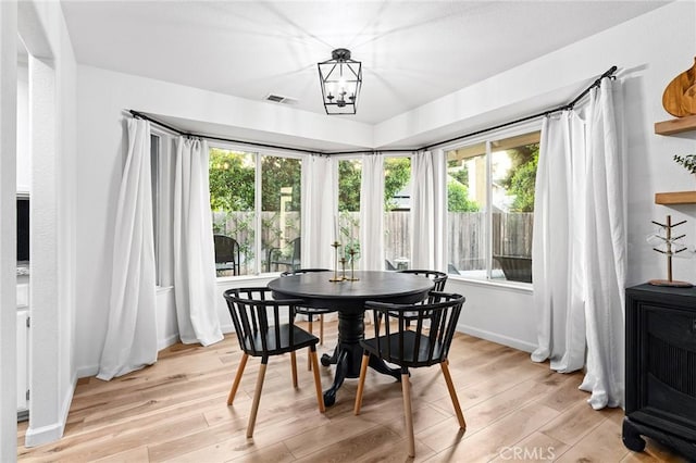 13 Noyo Ct, Chico, CA 95973 - dining space with light wood-type flooring, a chandelier, and baseboards