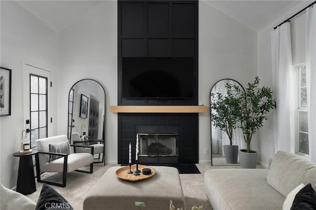 13 Noyo Ct, Chico, CA 95973 - carpeted living room with high vaulted ceiling, a tile fireplace, and baseboards