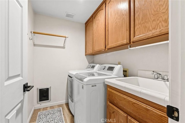 13 Noyo Ct, Chico, CA 95973 - laundry area with cabinet space, washer and clothes dryer, light wood-type flooring, and baseboards