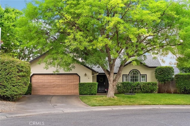 13 Noyo Ct, Chico, CA 95973 - obstructed view of property with driveway, a garage, a front lawn, and a shingled roof