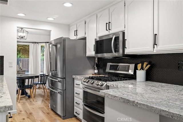 13 Noyo Ct, Chico, CA 95973 - kitchen featuring appliances with stainless steel finishes, white cabinetry, backsplash, light wood-type flooring, and recessed lighting