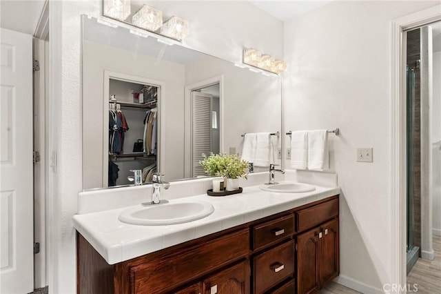 13 Noyo Ct, Chico, CA 95973 - full bath with double vanity, a spacious closet, a shower, and baseboards