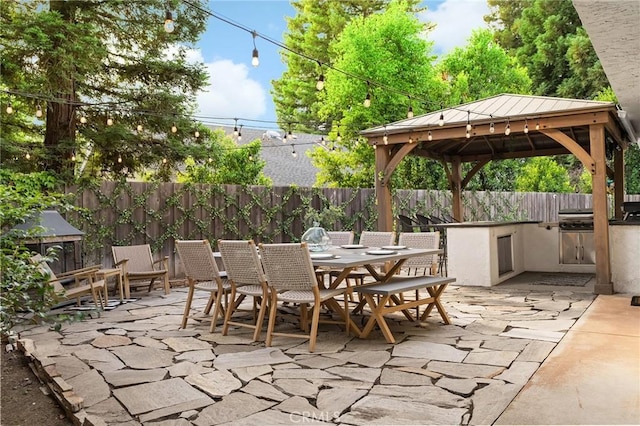 13 Noyo Ct, Chico, CA 95973 - fenced backyard with a patio area, an outdoor kitchen, outdoor dining space, and a gazebo