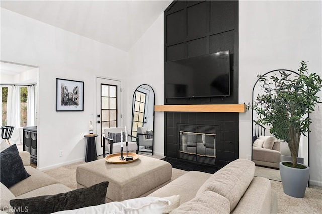 13 Noyo Ct, Chico, CA 95973 - carpeted living room featuring high vaulted ceiling, baseboards, and a tile fireplace