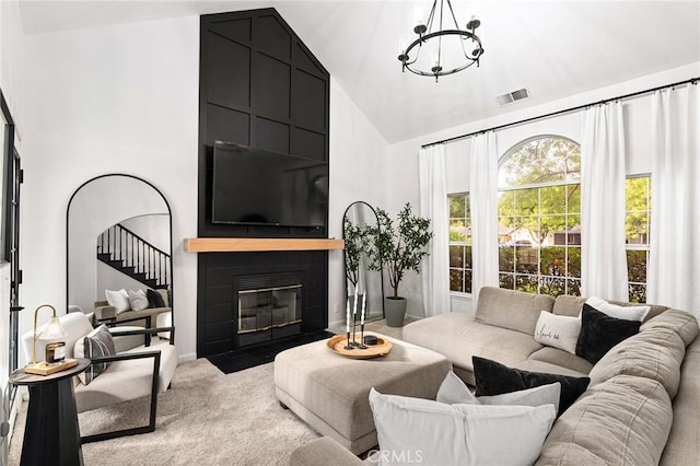 13 Noyo Ct, Chico, CA 95973 - living room featuring a chandelier, carpet, high vaulted ceiling, and a large fireplace