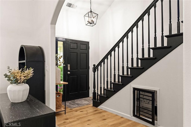 13 Noyo Ct, Chico, CA 95973 - entryway featuring wood finished floors, a chandelier, baseboards, arched walkways, and stairway
