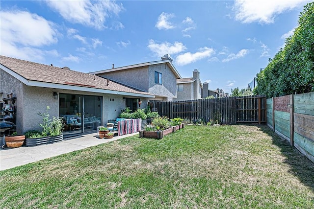 1168 E Foster Rd Unit B, Santa Maria, CA 93455 - rear view of property featuring a garden, a fenced backyard, and stucco siding