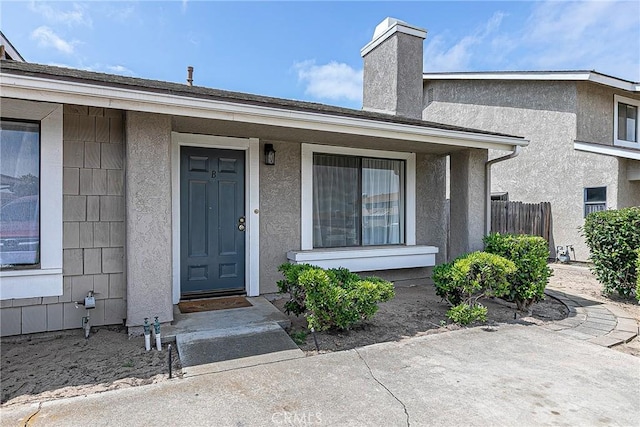 1168 E Foster Rd Unit B, Santa Maria, CA 93455 - property entrance with a chimney and stucco siding