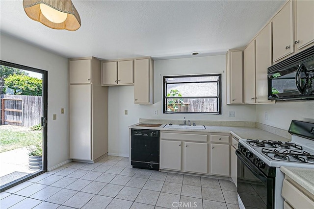 1168 E Foster Rd Unit B, Santa Maria, CA 93455 - kitchen featuring black appliances, light countertops, cream cabinets, light tile patterned floors, and a textured ceiling