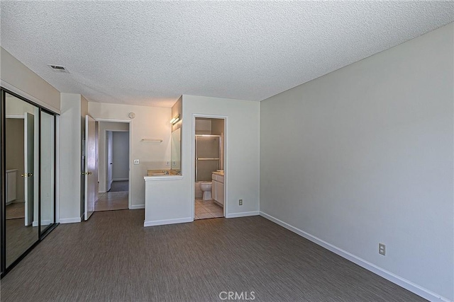 1168 E Foster Rd Unit B, Santa Maria, CA 93455 - unfurnished bedroom featuring a textured ceiling, a closet, and ensuite bathroom
