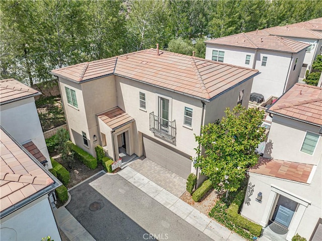 21836 Moveo Dr, Saugus, CA 91350 - view of front facade featuring stucco siding, a tiled roof, and driveway
