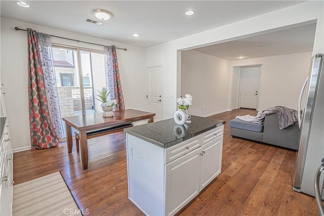 21836 Moveo Dr, Saugus, CA 91350 - kitchen with white cabinetry, dark wood-style floors, a kitchen island, freestanding refrigerator, and recessed lighting