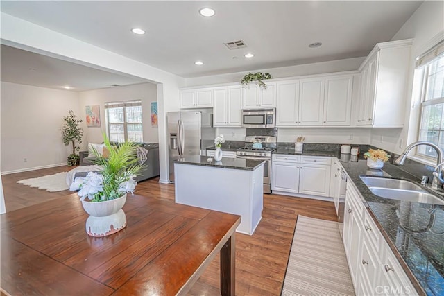 21836 Moveo Dr, Saugus, CA 91350 - kitchen with stainless steel appliances, plenty of natural light, a kitchen island, white cabinets, and recessed lighting