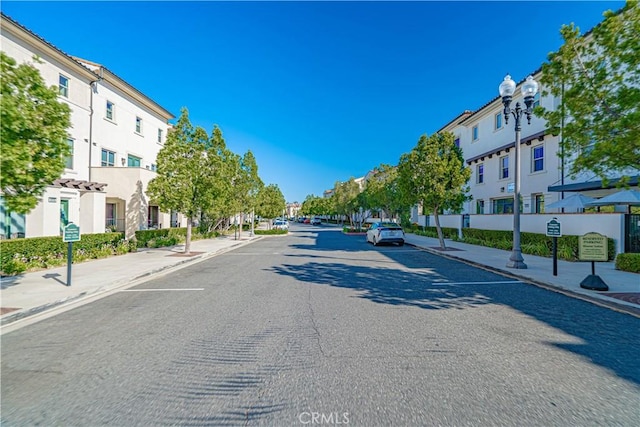 21836 Moveo Dr, Saugus, CA 91350 - view of asphalt road with sidewalks, curbs, a residential view, and street lights