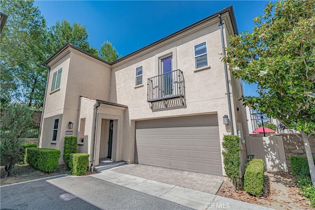 21836 Moveo Dr, Saugus, CA 91350 - view of front of property featuring a balcony, asphalt driveway, stucco siding, and a garage