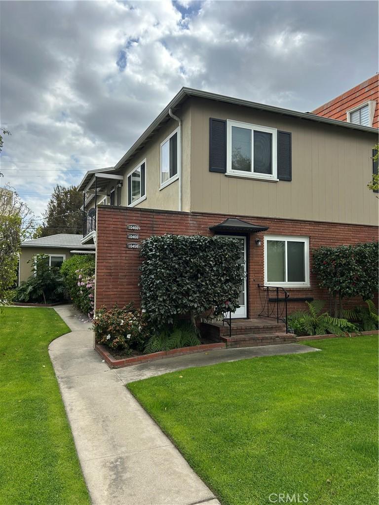 10458 Riverside Dr, Toluca Lake, CA 91602 - view of front of house featuring brick siding and a front lawn