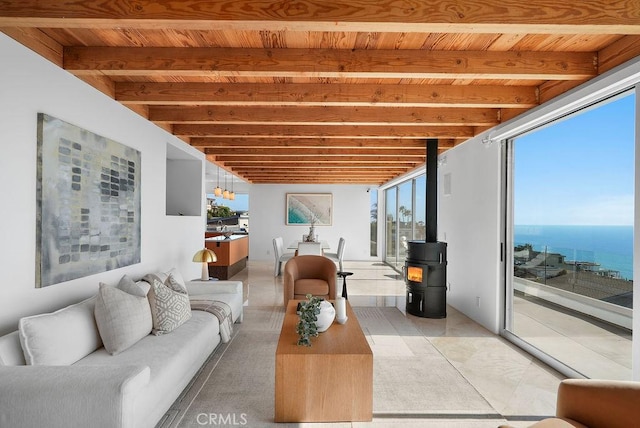 1119 Katella St, Laguna Beach, CA 92651 - living area with wooden ceiling with exposed beams, a wood stove, and a water view