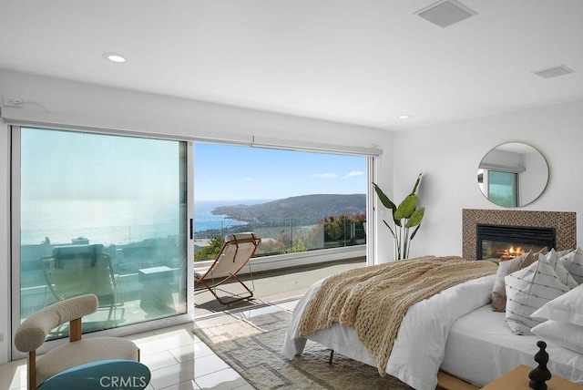 1119 Katella St, Laguna Beach, CA 92651 - bedroom featuring multiple windows, access to exterior, a tile fireplace, recessed lighting, and tile patterned flooring