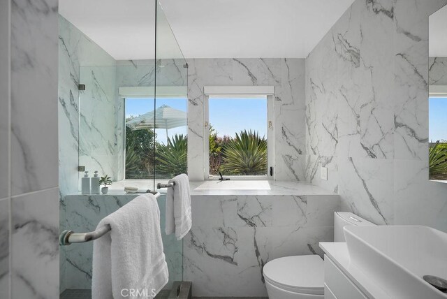 1119 Katella St, Laguna Beach, CA 92651 - bathroom featuring tile walls, toilet, vanity, and stone wall